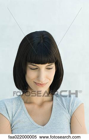 Young woman smirking, portrait View Large Photo Image Stock Photography - Young woman smirking, portrait. Fotosearch