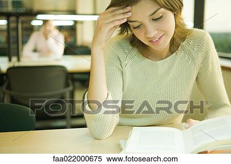 Young woman studying in university library View Large Photo Image Stock Photography - Young woman studying in university library. Fotosearch