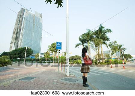 Young woman waiting to cross street View Large Photo Image Stock Photo - Young woman waiting to cross street. Fotosearch