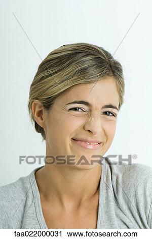 Young woman wrinkling nose, portrait View Large Photo Image Stock Image - Young woman wrinkling nose, portrait. Fotosearch
