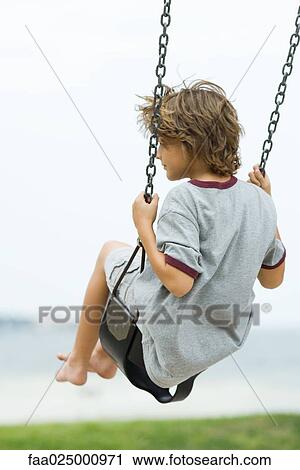 Barefoot boy on swing, rear view View Large Photo Image Stock Image - Barefoot boy on swing, rear view. Fotosearch