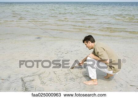 Barefoot man writing word "free" on beach with stick, full length View Large Photo Image Stock Image - Barefoot man writing word "free" on beach with stick, full length. Fotosearch