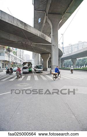 Bike and car traffic under overpasses View Large Photo Image Picture - Bike and car traffic under overpasses. Fotosearch