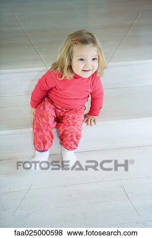Blonde toddler girl sitting on steps, smiling View Large Photo Image Stock Photo - Blonde toddler girl sitting on steps, smiling. Fotosearch