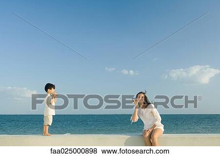 Boy and young woman using tin can phones View Large Photo Image Stock Photo - Boy and young woman using tin can phones. Fotosearch