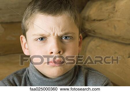 Boy frowning at camera, portrait View Large Photo Image Stock Image - Boy frowning at camera, portrait. Fotosearch