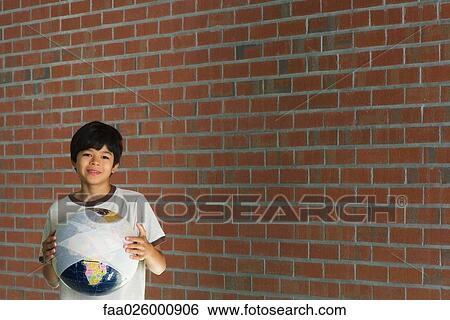 Boy holding globe wrapped in bandages, smiling at camera View Large Photo Image Stock Photograph - Boy holding globe wrapped in bandages, smiling at camera. Fotosearch