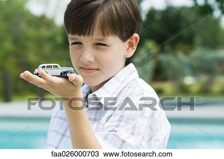 Boy holding toy car in palm of hand View Large Photo Image Stock Image - Boy holding toy car in palm of hand. Fotosearch