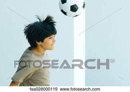 Boy playing with soccer ball, side view View Large Photo Image Stock Photo - Boy playing with soccer ball, side view. Fotosearch