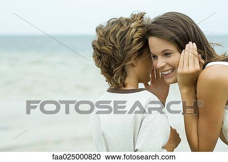 Boy whispering in teen sister's ear, close-up View Large Photo Image Stock Image - Boy whispering in teen sister's ear, close-up. Fotosearch
