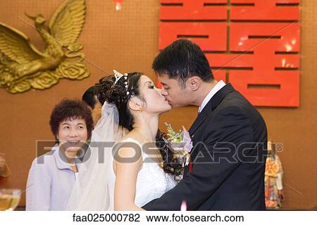 Bride and groom kissing, side view View Large Photo Image Stock Image - Bride and groom kissing, side view. Fotosearch