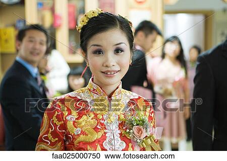 Bride dressed in traditional Chinese clothing, smiling at camera, portrait View Large Photo Image Stock Image - Bride dressed in traditional Chinese clothing, smiling at camera, portrait. Fotosearch