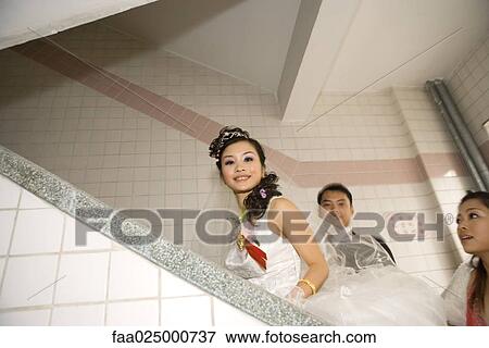Bride, groom and bridesmaid walking up stairs View Large Photo Image Stock Photo - Bride, groom and bridesmaid walking up stairs. Fotosearch