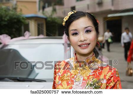 Bride wearing traditional Chinese clothing, smiling at camera, portrait View Large Photo Image Stock Photo - Bride wearing traditional Chinese clothing, smiling at camera, portrait. Fotosearch