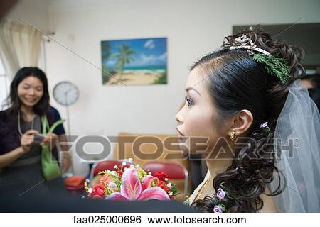 Bride wearing veil, sprig of evergreen in hair, in home interior, profile View Large Photo Image Stock Photograph - Bride wearing veil, sprig of evergreen in hair, in home interior, profile. Fotosearch