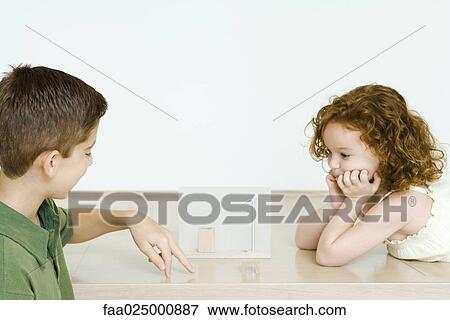 Brother and sister playing together View Large Photo Image Stock Photo - Brother and sister playing together. Fotosearch