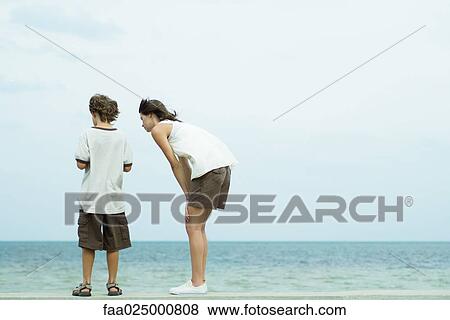 Brother and sister standing at the beach looking down together, rear view View Large Photo Image Stock Photo - Brother and sister standing at the beach looking down together, rear view. Fotosearch