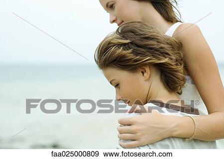 Brother and sister standing at the beach together, looking away, cropped view View Large Photo Image Stock Photo - Brother and sister standing at the beach together, looking away, cropped view. Fotosearch