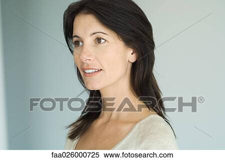 Brunette woman, smiling, looking away, head and shoulders, portrait View Large Photo Image Stock Photography - Brunette woman, smiling, looking away, head and shoulders, portrait. Fotosearch