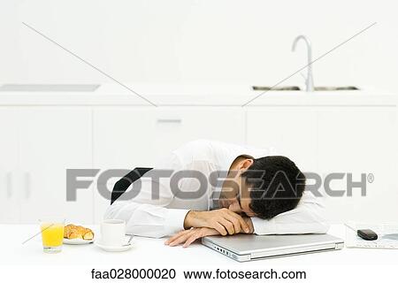 Businessman at breakfast table, resting head on laptop computer, eyes closed View Large Photo Image Stock Image - Businessman at breakfast table, resting head on laptop computer, eyes closed. Fotosearch