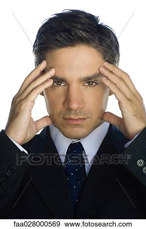 Businessman holding head, looking at camera View Large Photo Image Stock Photo - Businessman holding head, looking at camera. Fotosearch