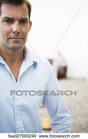 Businessman looking at camera, portrait View Large Photo Image Stock Image - Businessman looking at camera, portrait. Fotosearch