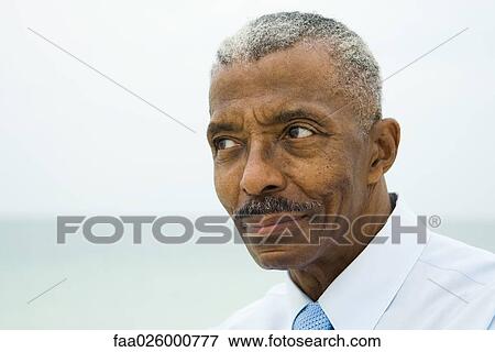 Stock Photo - Businessman looking away, portrait. Fotosearch