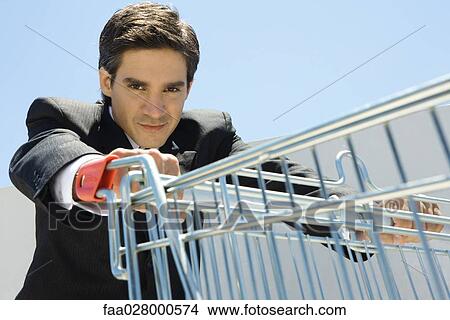 Businessman pushing grocery cart View Large Photo Image Picture - Businessman pushing grocery cart. Fotosearch