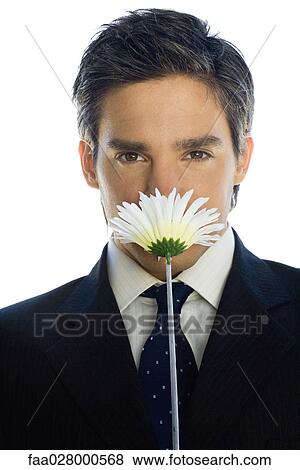 Businessman smelling flower View Large Photo Image Stock Photo - Businessman smelling flower. Fotosearch