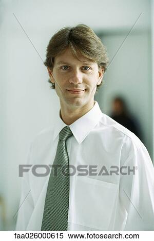 Businessman smiling at camera, portrait View Large Photo Image Stock Photography - Businessman smiling at camera, portrait. Fotosearch