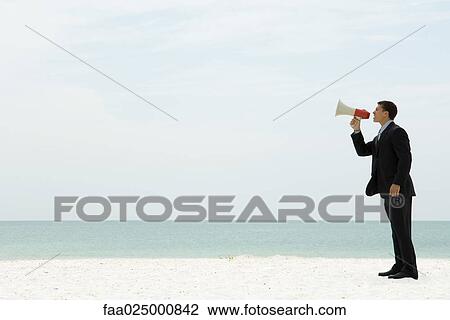 Businessman standing at the beach shouting into megaphone View Large Photo Image Stock Image - Businessman standing at the beach shouting into megaphone. Fotosearch