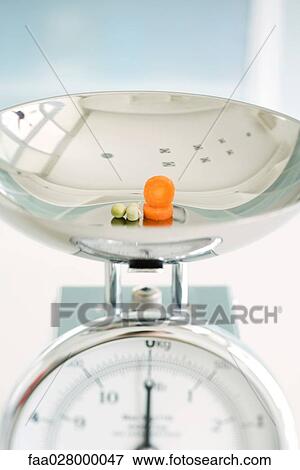Capers and carrot slices on weight scale, close-up View Large Photo Image Stock Photo - Capers and carrot slices on weight scale, close-up. Fotosearch