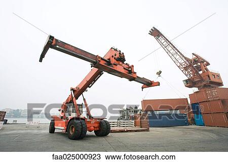 Stock Image - Cargo loader in shipyard. Fotosearch