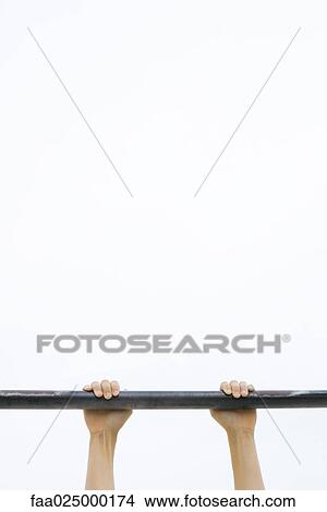 Child hanging on to metal bar, cropped view of hands View Large Photo Image Picture - Child hanging on to metal bar, cropped view of hands. Fotosearch