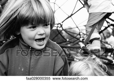 Child on playground looking away, hair tousled by wind, close-up View Large Photo Image Stock Photography - Child on playground looking away, hair tousled by wind, close-up. Fotosearch