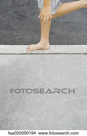 Child standing on one leg, cropped high angle view View Large Photo Image Picture - Child standing on one leg, cropped high angle view. Fotosearch