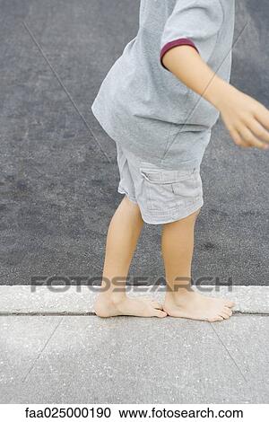 Child walking along crack in sidewalk, cropped view View Large Photo Image Stock Image - Child walking along crack in sidewalk, cropped view. Fotosearch