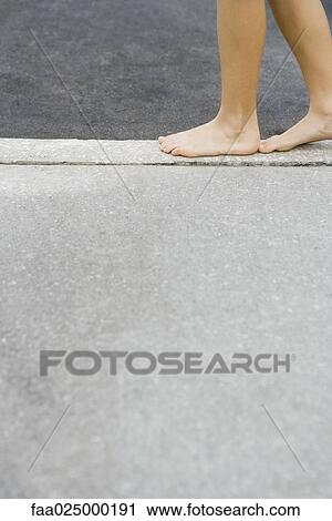 Child walking along crack in sidewalk, cropped view of feet View Large Photo Image Stock Image - Child walking along crack in sidewalk, cropped view of feet. Fotosearch