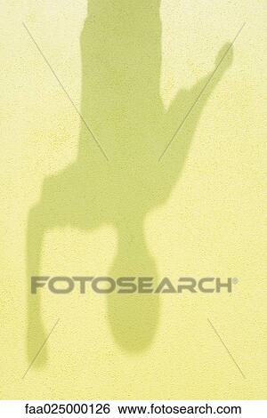 Stock Photograph - Child's shadow on the ground, close-up. Fotosearch