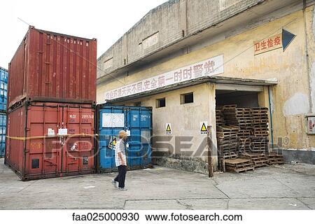 China, man walking through industrial area View Large Photo Image Stock Image - China, man walking through industrial area. Fotosearch