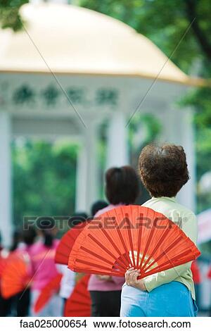 China, women dancing with fans, outdoors View Large Photo Image Picture - China, women dancing with fans, outdoors. Fotosearch