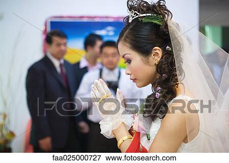 Chinese wedding, bride's hands clasped in prayer, side view View Large Photo Image Stock Photo - Chinese wedding, bride's hands clasped in prayer, side view. Fotosearch