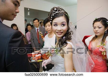 Chinese wedding tea ceremony, bride looking over shoulder View Large Photo Image Stock Photo - Chinese wedding tea ceremony, bride looking over shoulder. Fotosearch