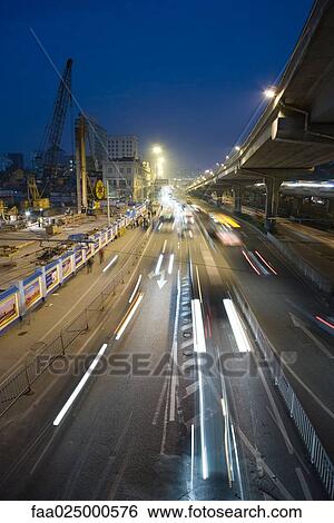City traffic next to construction site at night, high angle view View Large Photo Image Stock Photograph - City traffic next to construction site at night, high angle view. Fotosearch