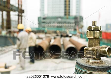 Construction site, focus on spigot in foreground View Large Photo Image Stock Photo - Construction site, focus on spigot in foreground. Fotosearch