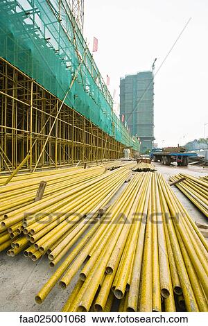 Stock Photo - Construction site, metal beams on ground. Fotosearch