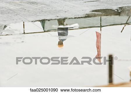 Construction worker at construction site, reflected in puddle of water View Large Photo Image Stock Image - Construction worker at construction site, reflected in puddle of water. Fotosearch