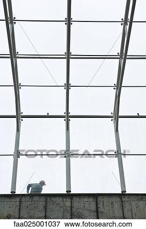 Stock Photo - Construction worker seen through framework. Fotosearch
