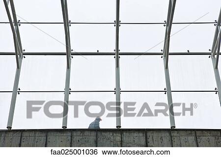 Stock Photograph - Construction worker seen through framework. Fotosearch