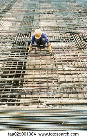 Construction worker working at construction site View Large Photo Image Picture - Construction worker working at construction site. Fotosearch
